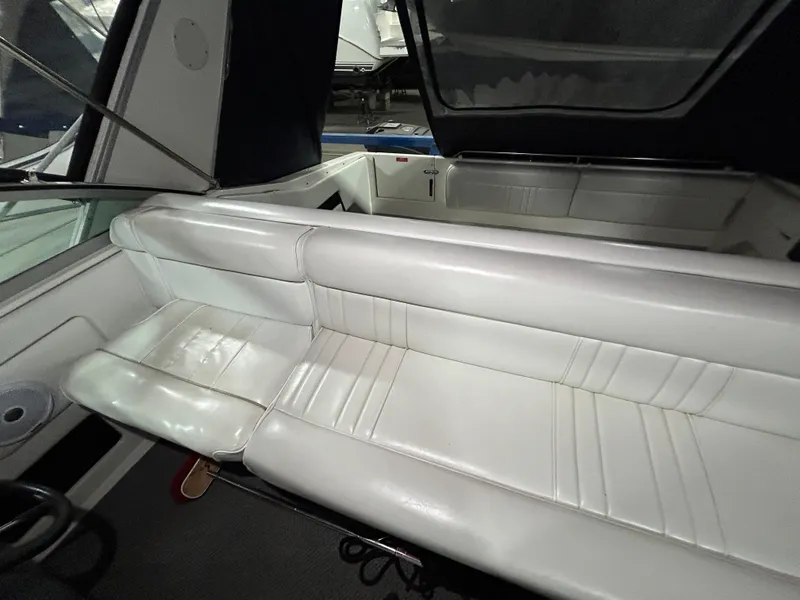Slide: The Image of 1992 Sea Ray 370 Sundancer interior with white leather seating and cockpit view. - 29