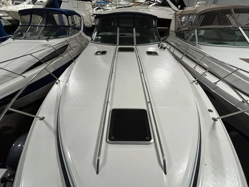Slide: The Image of 1992 Sea Ray 370 Sundancer boat docked among other vessels in a marina. - 30