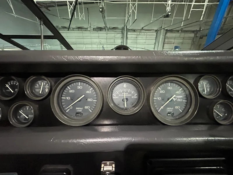 Slide: The Image of Dashboard of a 1992 Sea Ray 370 Sundancer with multiple gauges and dials. - 32