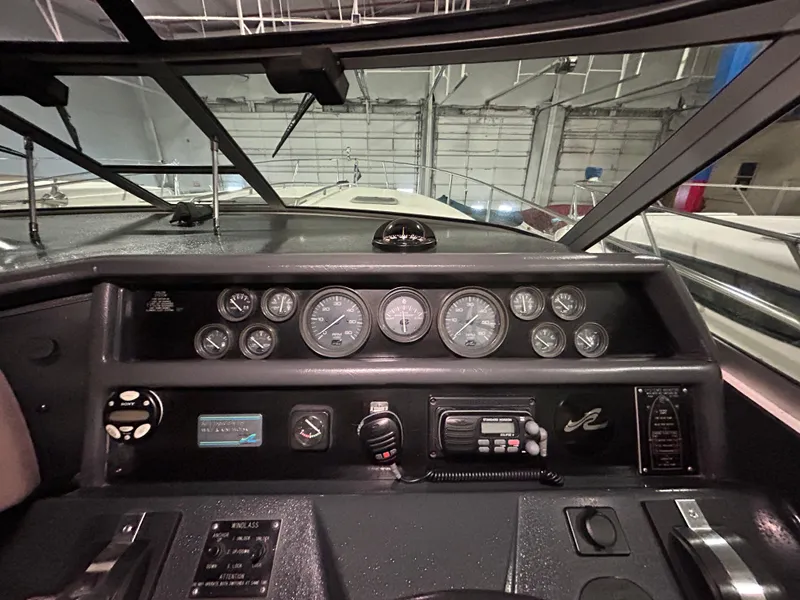 Slide: The Image of Dashboard of a 1992 Sea Ray 370 Sundancer boat with gauges and controls. - 35