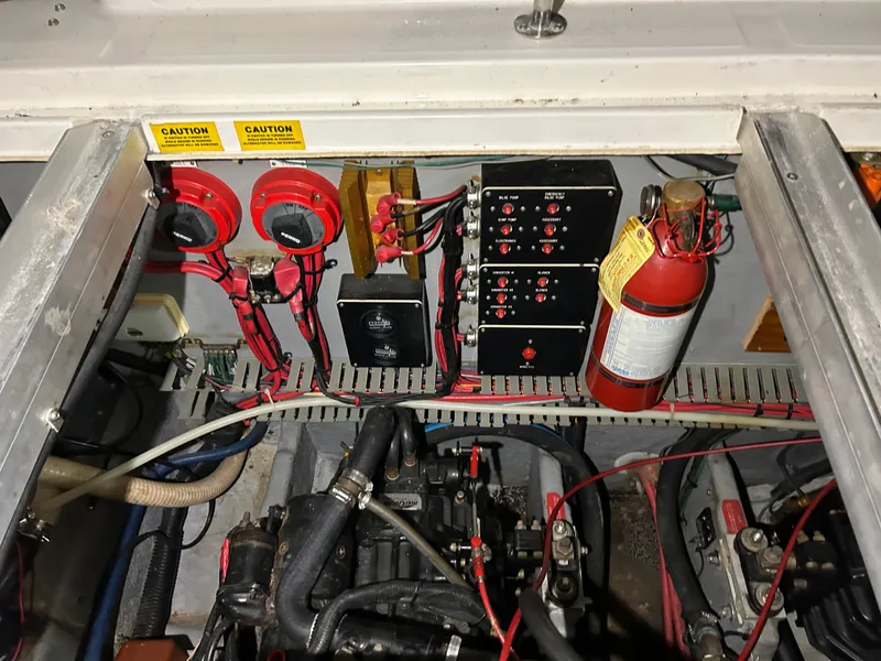 Slide: The Image of Engine compartment of a 1992 Sea Ray 370 Sundancer with electrical components and fire extinguisher. - 37