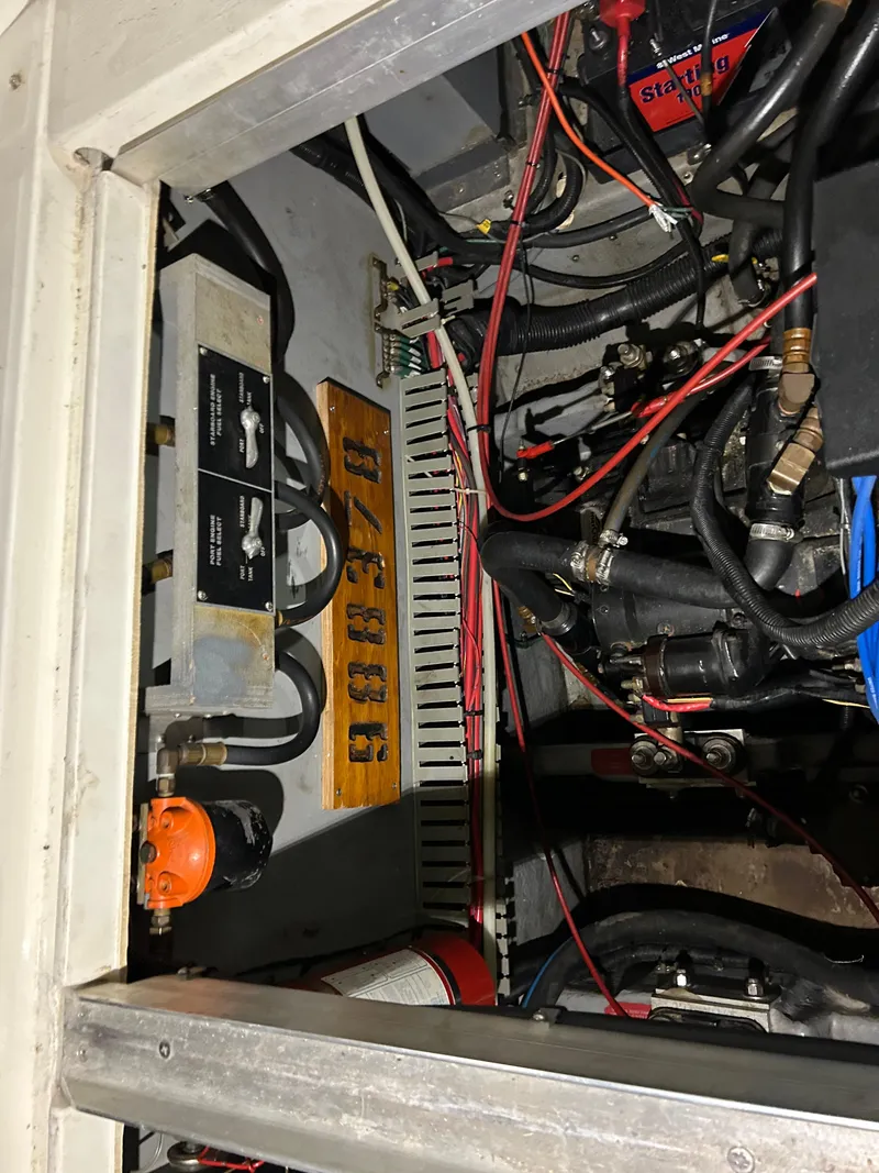 Slide: The Image of Engine compartment of a 1992 Sea Ray 370 Sundancer with visible wiring and components. - 38