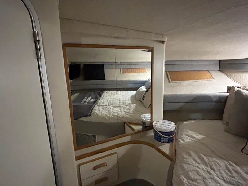 Slide: The Image of Interior cabin of 1992 Sea Ray 370 Sundancer with bed, mirror, and storage. - 4