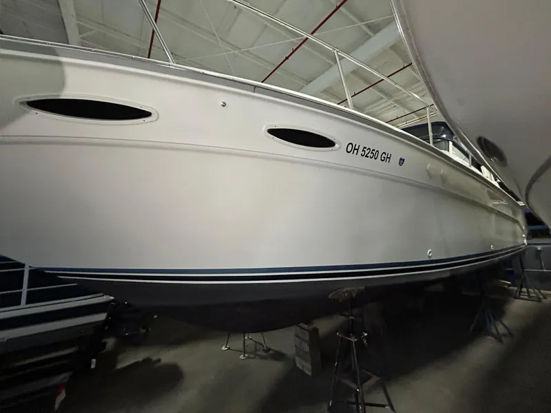 Slide: The Image of 1992 Sea Ray 370 Sundancer boat in storage, side view, white hull, indoors. - 40