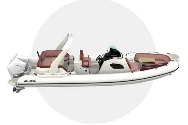 Slide: The Image of 2025 Zodiac Medline 9 boat interior with cushioned seating and wooden table. - 17