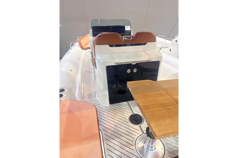 Slide: The Image of 2025 Zodiac Medline 9 boat interior with seating and wooden table. - 2