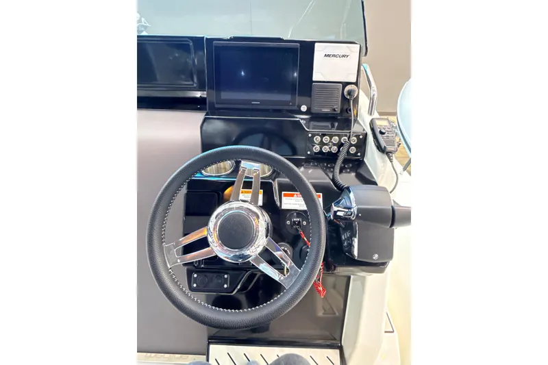 Slide: The Image of 2025 Zodiac Medline 9 boat dashboard with steering wheel and control panel. - 5