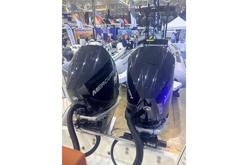 Slide: The Image of Twin Mercury outboard engines on a 2025 Zodiac Medline 9 at a boat show. - 9