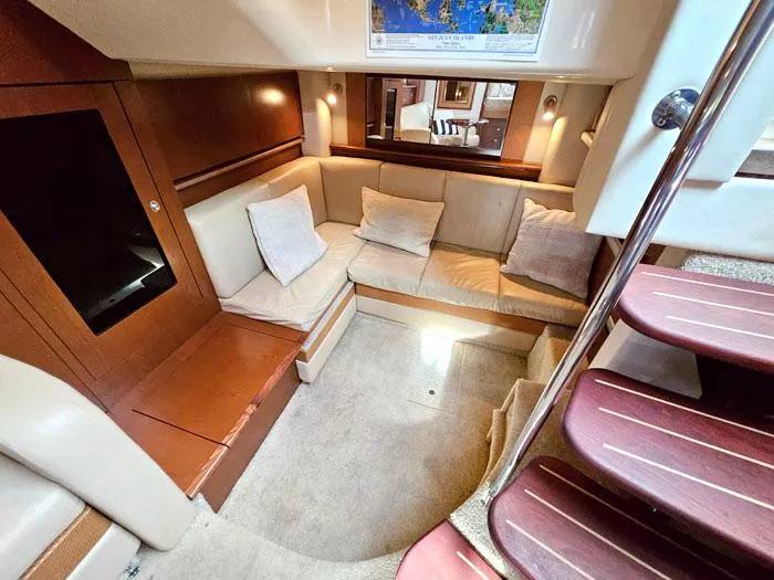 Slide: The Image of Interior of 2007 Sea Ray 40 Sundancer yacht with cozy seating and elegant wood finishes. - 12