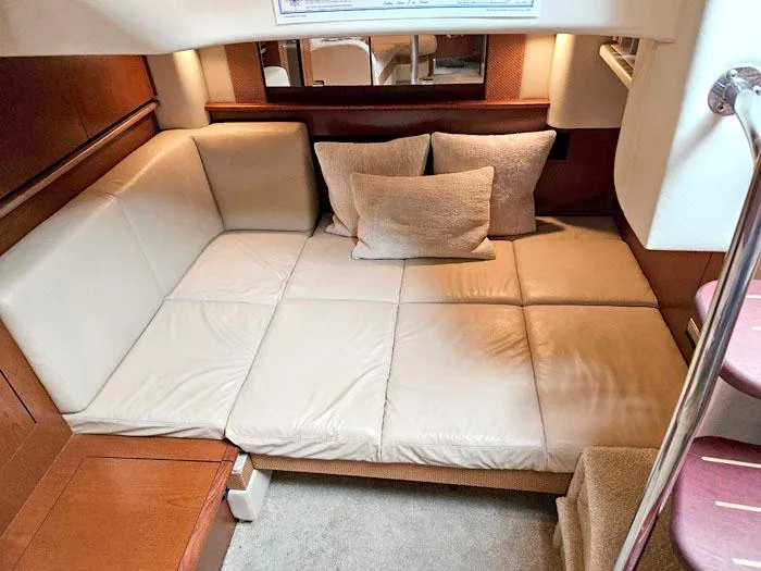 Slide: The Image of Interior of 2007 Sea Ray 40 Sundancer with beige leather seating and cushions. - 13