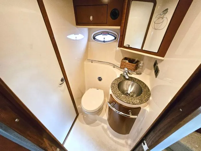 Slide: The Image of Luxurious bathroom in 2007 Sea Ray 40 Sundancer yacht with modern fixtures and porthole window. - 15