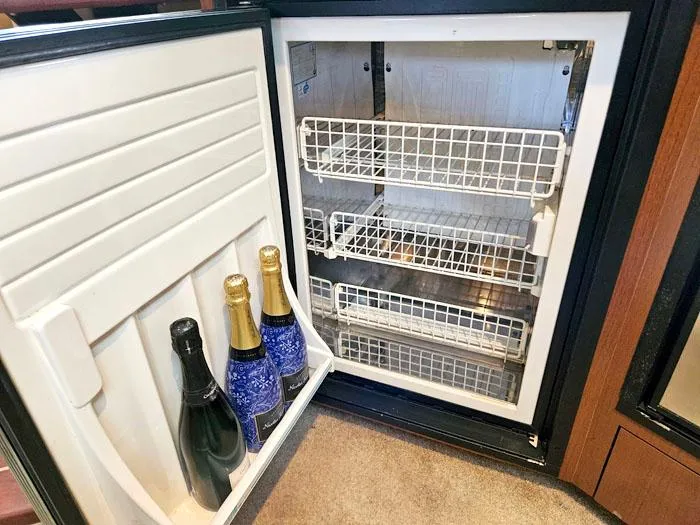 Slide: The Image of Open fridge on 2007 Sea Ray 40 Sundancer with champagne bottles inside. - 18