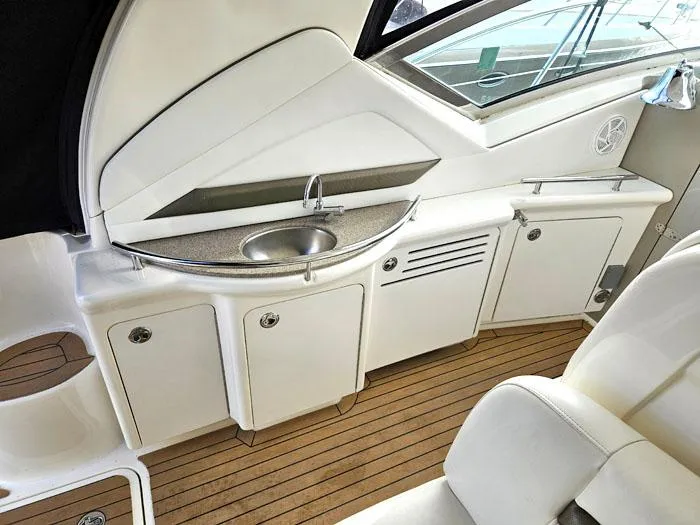 Slide: The Image of 2007 Sea Ray 40 Sundancer yacht interior with sink and cabinets on teak flooring. - 7