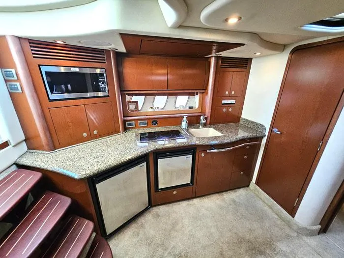 Slide: The Image of Luxurious 2007 Sea Ray 40 Sundancer yacht interior with modern kitchen amenities. - 9
