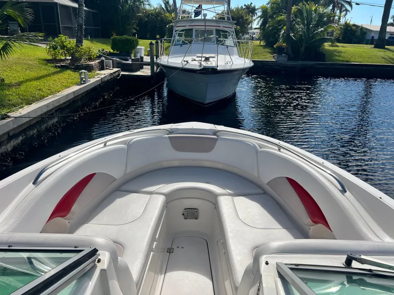 Slide: The Image of 2015 Chaparral 287 SSX boat docked in a scenic canal setting. - 10