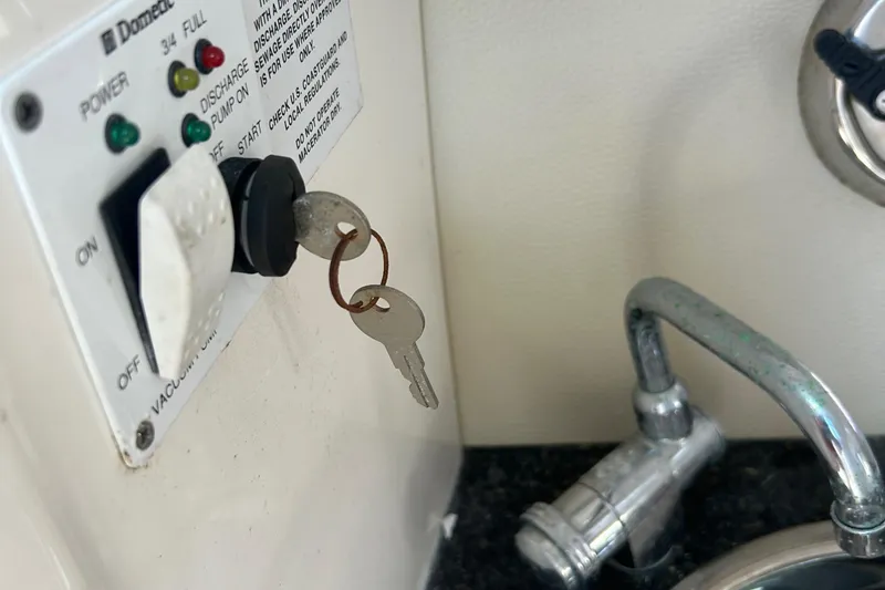 Slide: The Image of Keys in ignition of 2015 Chaparral 287 SSX boat, near control panel and faucet. - 15
