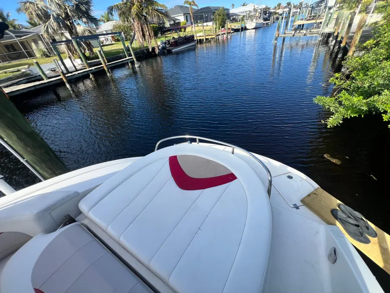 Slide: The Image of 2015 Chaparral 287 SSX boat docked by a scenic waterfront. - 3