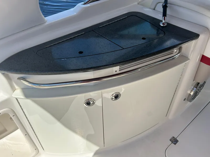 Slide: The Image of 2015 Chaparral 287 SSX boat interior with sleek countertop and storage cabinets. - 6