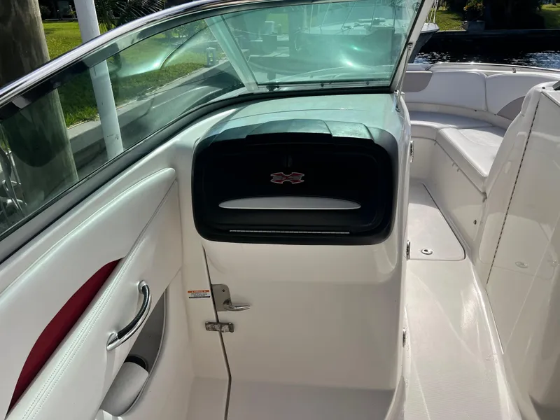 Slide: The Image of 2015 Chaparral 287 SSX boat interior with white seating and sleek dashboard. - 8