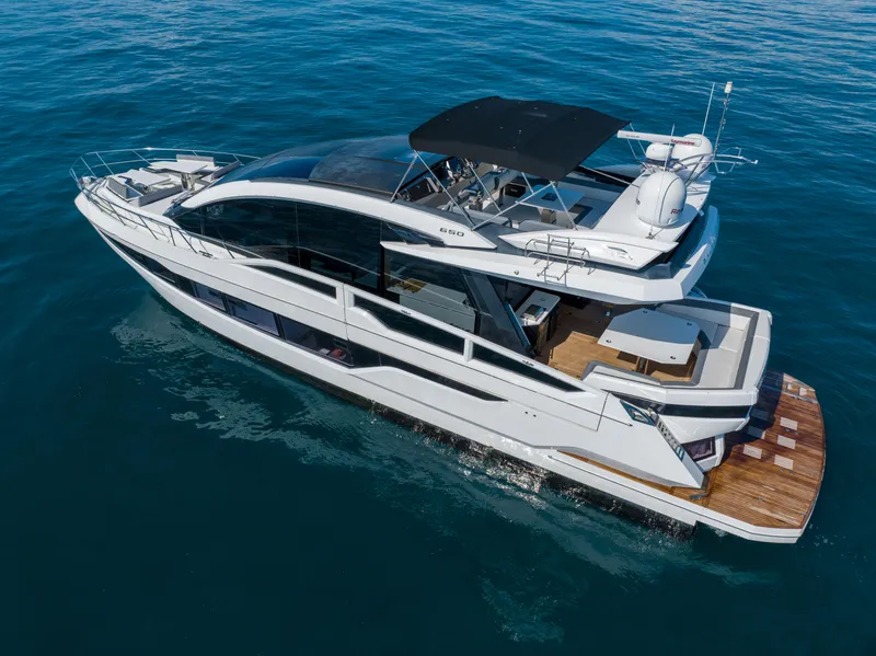 Slide: The Image of 2019 Galeon 650 Sky yacht cruising on open water. - 10