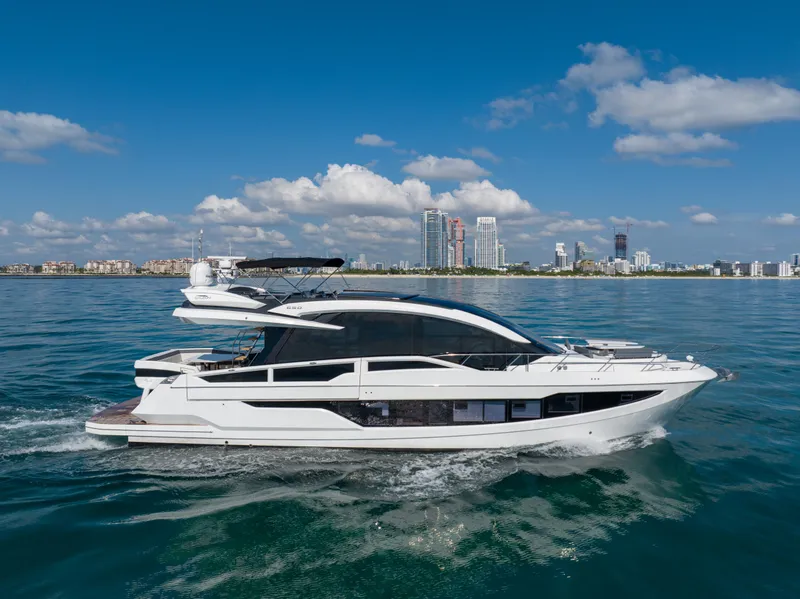 Slide: The Image of Galeon 650 Sky yacht cruising near city skyline, 2019 model. - 2