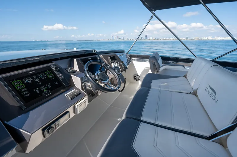 Slide: The Image of 2019 Galeon 650 Sky yacht cockpit with modern controls and ocean view. - 21