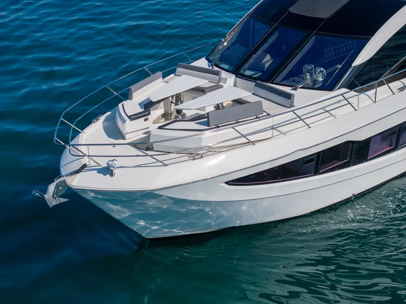 Slide: The Image of Luxury 2019 Galeon 650 Sky yacht cruising on clear blue water. - 7