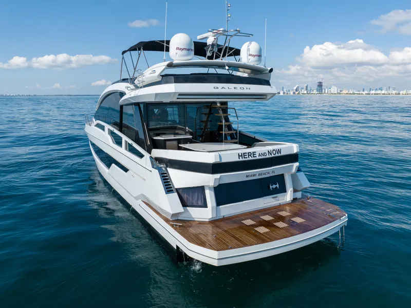 Slide: The Image of 2019 Galeon 650 Sky yacht cruising near Miami Beach, clear blue waters. - 8