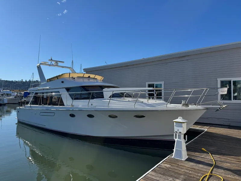 Slide: The Image of 1991 Ocean Alexander 46 yacht docked at marina under clear blue sky. - 1