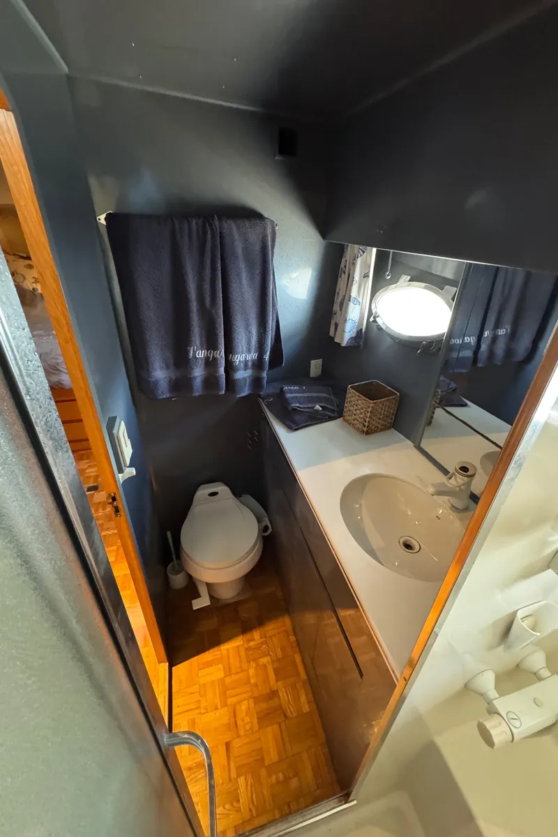 Slide: The Image of Bathroom interior of 1991 Ocean Alexander 46 yacht with sink, toilet, and mirror. - 25