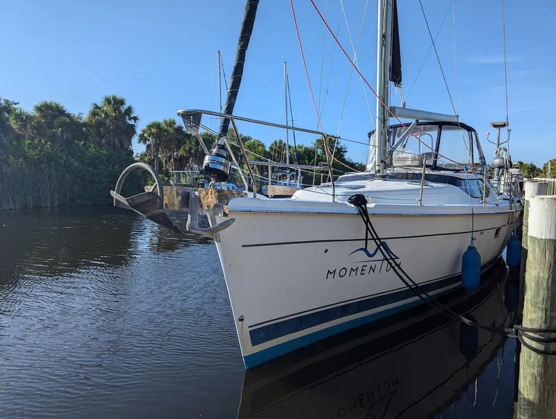 Slide: The Image of 2007 Hunter 45 CC sailboat docked on a calm river. - 1