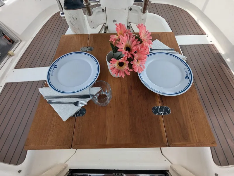 Slide: The Image of Elegant dining setup on 2007 Hunter 45 CC yacht with flowers and tableware. - 11