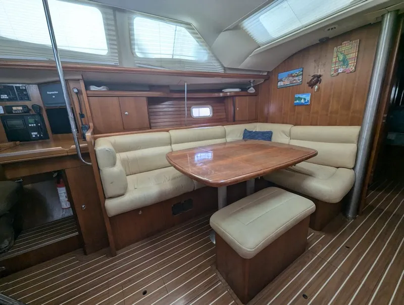 Slide: The Image of Interior of 2007 Hunter 45 CC sailboat with wooden table and beige seating. - 12