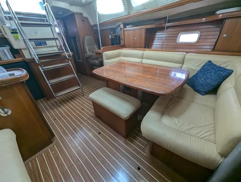 Slide: The Image of Interior of 2007 Hunter 45 CC yacht with wooden flooring and cozy seating area. - 13
