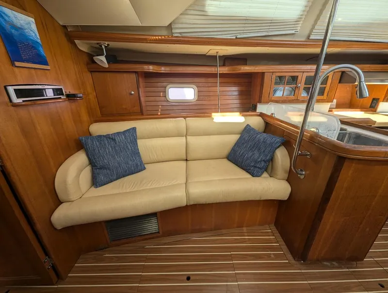 Slide: The Image of Luxurious 2007 Hunter 45 CC yacht interior with beige sofa and blue cushions. - 14