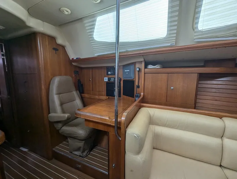 Slide: The Image of Interior of 2007 Hunter 45 CC sailboat with wood paneling and beige seating. - 16