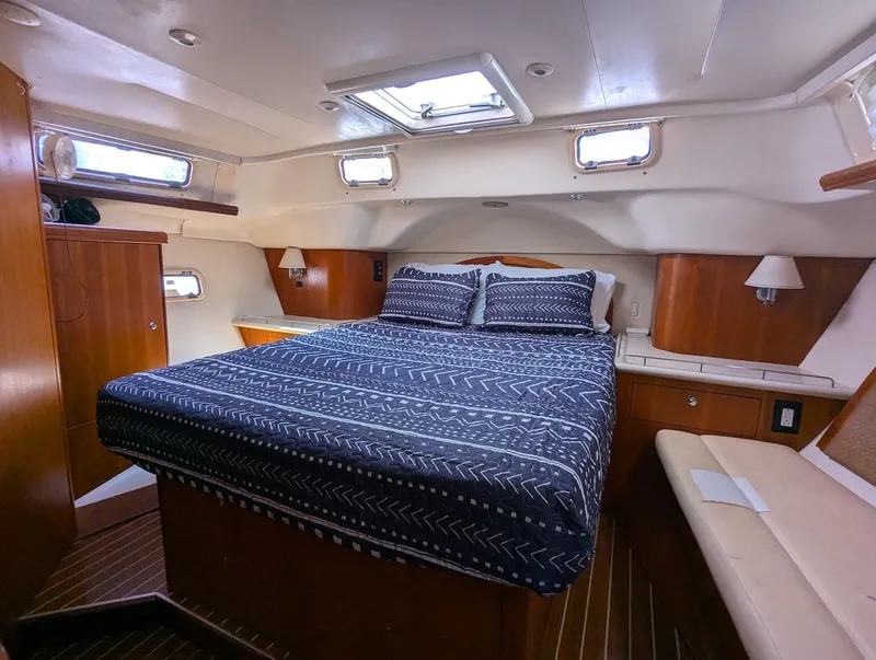 Slide: The Image of Luxurious cabin interior of 2007 Hunter 45 CC sailboat with cozy bed and wooden accents. - 19