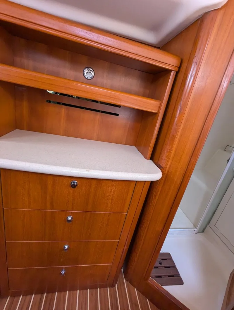Slide: The Image of 2007 Hunter 45 CC yacht interior with wooden cabinetry and drawers. - 20