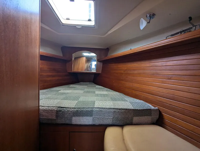 Slide: The Image of Cozy cabin interior of 2007 Hunter 45 CC sailboat with wood paneling and skylight. - 23