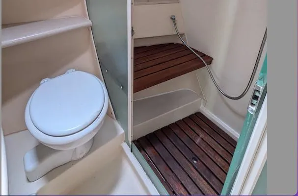 Slide: The Image of 2007 Hunter 45 CC yacht bathroom with toilet and wooden shower floor. - 24