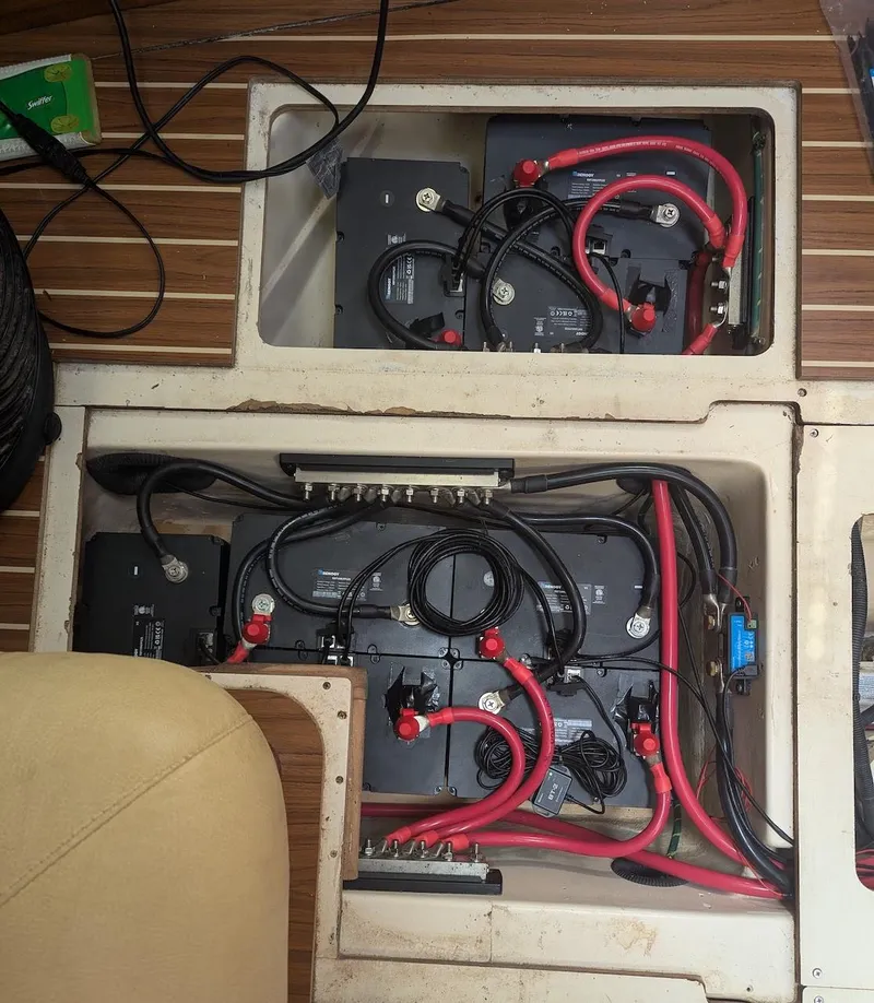 Slide: The Image of 2007 Hunter 45 CC boat battery compartment with wiring and connections. - 26
