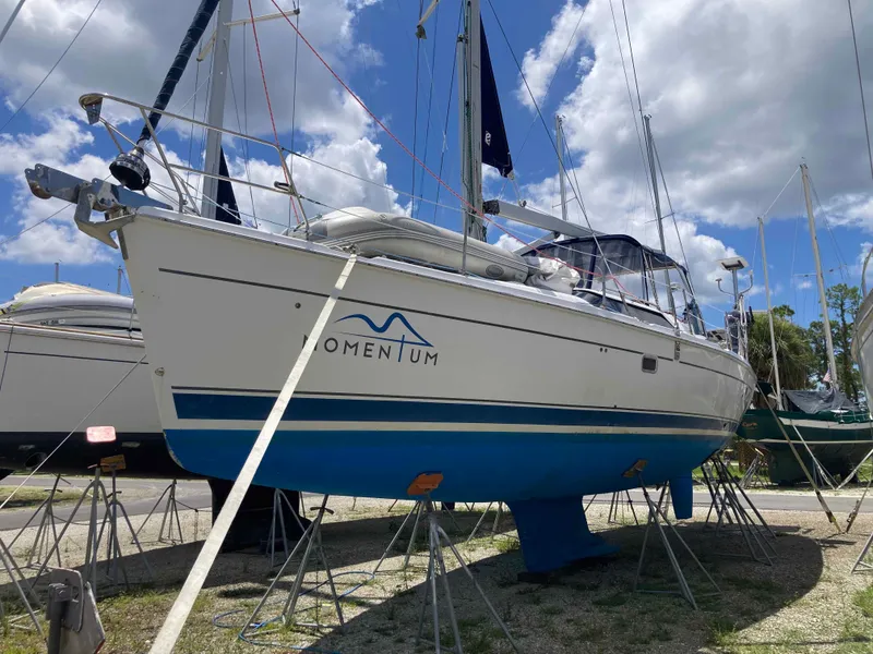 Slide: The Image of 2007 Hunter 45 CC sailboat on stands, blue hull, clear sky background. - 4