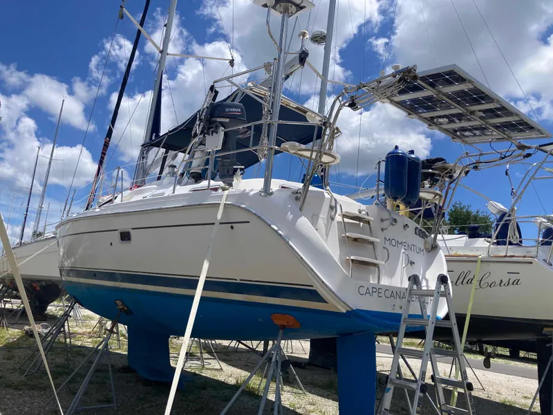 Slide: The Image of 2007 Hunter 45 CC sailboat on stands, featuring solar panels, under a partly cloudy sky. - 5