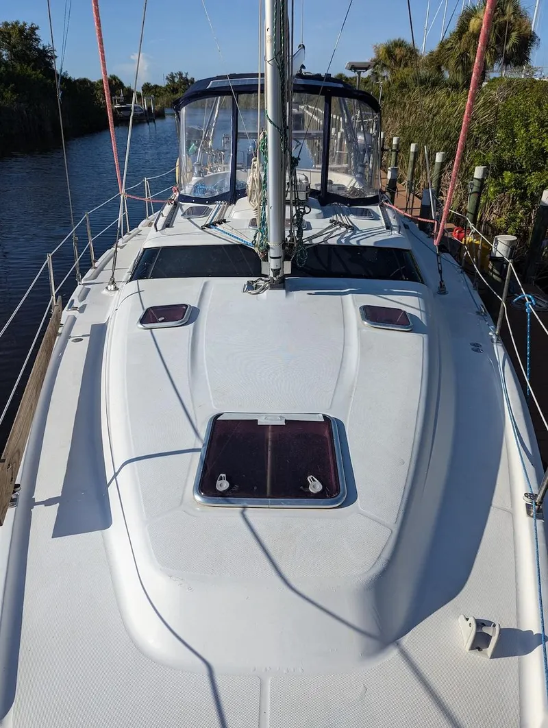 Slide: The Image of 2007 Hunter 45 CC sailboat docked, featuring sleek deck design and spacious cockpit. - 6