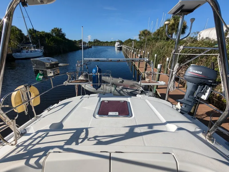 Slide: The Image of 2007 Hunter 45 CC sailboat docked in a serene marina setting. - 7