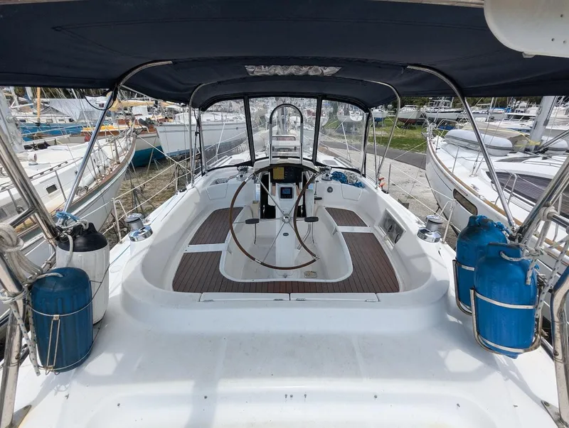 Slide: The Image of 2007 Hunter 45 CC sailboat cockpit with steering wheel and canopy. - 9