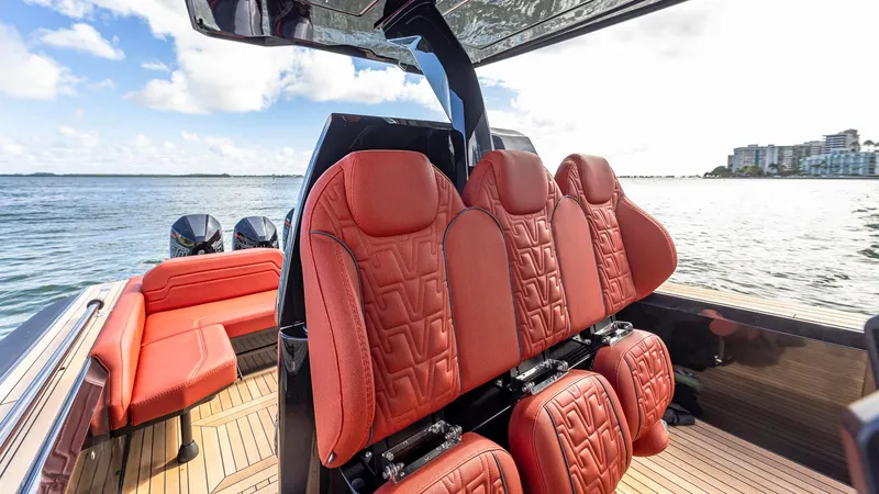 Slide: The Image of Luxurious red seating on 2025 Technohull Omega 47 boat, with scenic ocean view. - 10