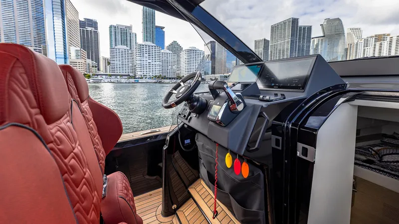 Slide: The Image of Technohull Omega 47 cockpit with city skyline, 2025 model, luxury boat interior. - 11