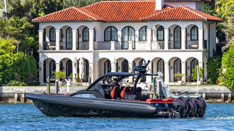 Slide: The Image of Technohull Omega 47 (2025) luxury boat cruising near a waterfront mansion. - 15