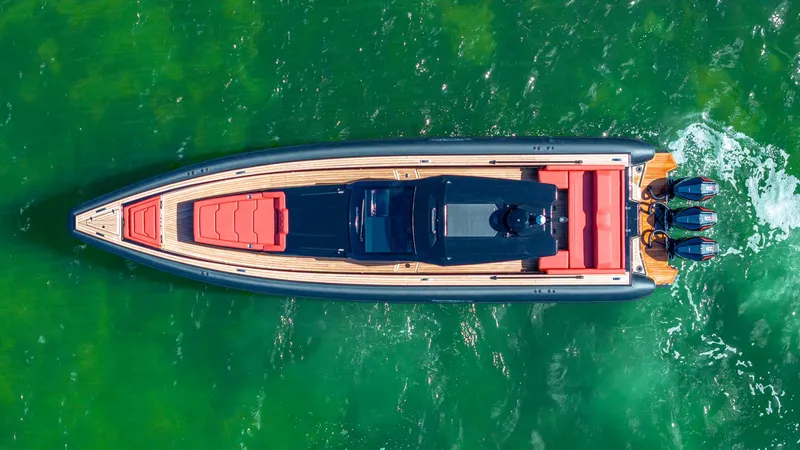 Slide: The Image of Aerial view of 2025 Technohull Omega 47 luxury boat on vibrant green water. - 6